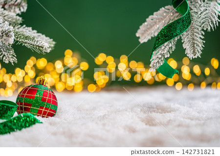 Red and Green Christmas Ornaments Under Frosted Branches Red and Green Christmas Ornaments Under Frosted Branches 142731821