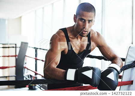 Latino man, boxer and portrait for fitness, exercise or training workout ready for fight at gym. Professional fighter, boxing and competitive sports for ring match, health and wellness with endurance Latino man, boxer and portrait for fitness, exercise or training workout ready for fight at gym. Professional fighter, boxing and competitive sports for ring match, health and wellness with endurance 142732122