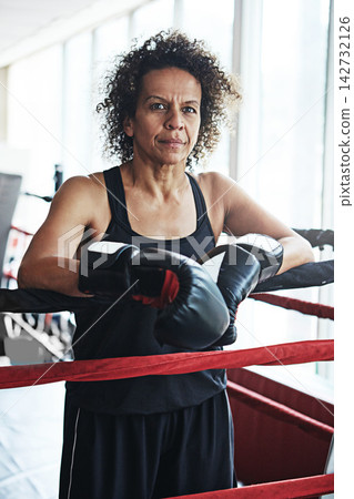 Mature woman, boxer and portrait for training, exercise or fitness workout ready for fight at gym. Female fighter, boxing and competitive sports for ring match, health and wellness with endurance Mature woman, boxer and portrait for training, exercise or fitness workout ready for fight at gym. Female fighter, boxing and competitive sports for ring match, health and wellness with endurance 142732126