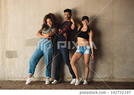 Gen z, friends and happy with fashion portrait by wall in city for bonding, streetwear and trendy outfit. Group, people and smile with confidence, pride and urban style outdoor in town with care Gen z, friends and happy with fashion portrait by wall in city for bonding, streetwear and trendy outfit. Group, people and smile with confidence, pride and urban style outdoor in town with care 142732197