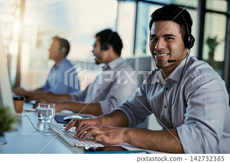 Customer service, sales and portrait of happy man with headset, coworking space and consulting at help desk. Phone call, conversation and advice at callcenter for telemarketing, smile and support. Customer service, sales and portrait of happy man with headset, coworking space and consulting at help desk. Phone call, conversation and advice at callcenter for telemarketing, smile and support. 142732385