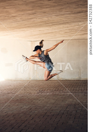 Woman, jump and dancing for hip hop in city with steps, freedom and flexible in training for concert. Girl, person and kick for culture, art and moving body with rhythm for performance on metro road Woman, jump and dancing for hip hop in city with steps, freedom and flexible in training for concert. Girl, person and kick for culture, art and moving body with rhythm for performance on metro road 142732388