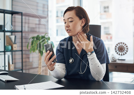 Doctor, phone and telehealth in hospital office for healthcare, health and wellness with medical advice. Female otolaryngologist, smartphone and video call as virtual diagnosis or treatment in throat Doctor, phone and telehealth in hospital office for healthcare, health and wellness with medical advice. Female otolaryngologist, smartphone and video call as virtual diagnosis or treatment in throat 142732408