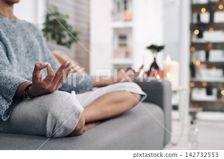 Mudra, hand and meditation on sofa in home for chakra connection, balance and mental health in morning. House, peace and zen person with spiritual healing for holistic, mindfulness and awareness Mudra, hand and meditation on sofa in home for chakra connection, balance and mental health in morning. House, peace and zen person with spiritual healing for holistic, mindfulness and awareness 142732553