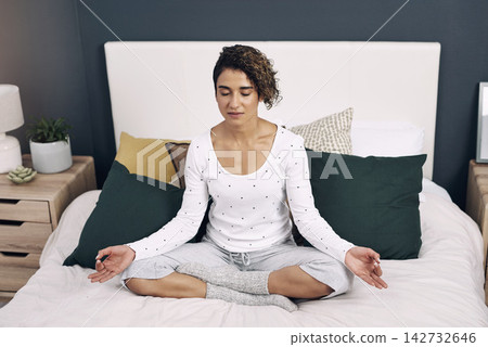 Woman, relax and meditation on bed in home for mindfulness, peace and mental health on weekend. Zen, house and person with chakra healing for holistic balance, connection and awareness in wisdom Woman, relax and meditation on bed in home for mindfulness, peace and mental health on weekend. Zen, house and person with chakra healing for holistic balance, connection and awareness in wisdom 142732646