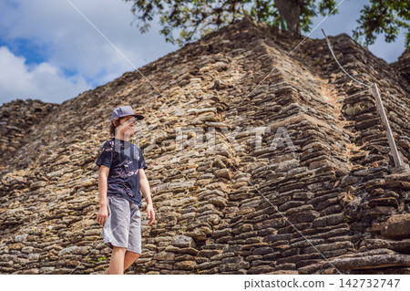 Boy tourist exploring the tall Tonina Maya pyramid and stone steps in Chiapas Mexico with pre Hispanic history stone walls cultural heritage Mexican archaeology and near viewpoint. Boy tourist exploring the tall Tonina Maya pyramid and stone steps in Chiapas Mexico with pre Hispanic history stone walls cultural heritage Mexican archaeology and near viewpoint. 142732747