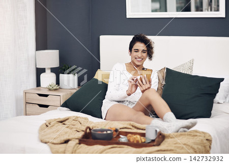 Bedroom, smile and woman with smartphone, breakfast and audio with social media, digital app and morning. Apartment, relax and girl with cellphone, nutrition and connection with sound and online news Bedroom, smile and woman with smartphone, breakfast and audio with social media, digital app and morning. Apartment, relax and girl with cellphone, nutrition and connection with sound and online news 142732932