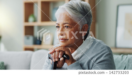 Elderly woman, sad and thinking with cane for disability, retirement and healthcare at nursing home. Depression, walking stick and senior person on sofa for arthritis, assistance and mental health Elderly woman, sad and thinking with cane for disability, retirement and healthcare at nursing home. Depression, walking stick and senior person on sofa for arthritis, assistance and mental health 142733203