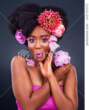 Beauty, flowers and wow portrait of black woman in studio on dark background for natural cosmetics. Face, makeup or surprise and young afro model with protea in hair for aesthetic wellness at spa Beauty, flowers and wow portrait of black woman in studio on dark background for natural cosmetics. Face, makeup or surprise and young afro model with protea in hair for aesthetic wellness at spa 142733372