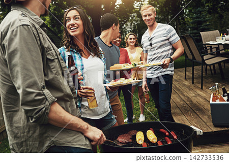 Friends, barbecue and help for serving with plate in backyard with diversity, cooking or meat on fire. People, men and women with beer, drink and relax for food by bbq grill on holiday in Australia 142733536