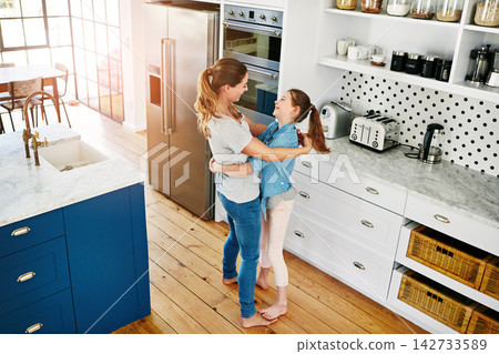 Home, kitchen and mom hug girl or dance with love, care and support in family on weekend. Happy, embrace and mother relax with child in morning or bonding chat with joy on holiday from above Home, kitchen and mom hug girl or dance with love, care and support in family on weekend. Happy, embrace and mother relax with child in morning or bonding chat with joy on holiday from above 142733589