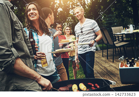 Group, drinks and bbq with food for dinner, party or reunion with alcohol in America. Friends, people and cheerful at barbecue in backyard, summer and vacation for holiday, celebration or birthday 142733623