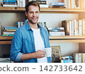 Portrait, home office and man with coffee, smile and researcher with project, white mug and relaxing. Face, happy person and reader in study, morning tea and espresso in cup, cappuccino and bookshelf 142733642
