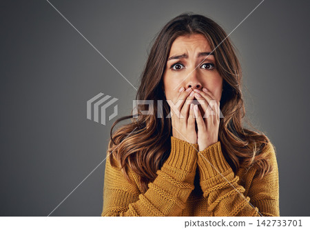 Portrait, scared and woman with fear, afraid and anxiety with secret news on grey studio background. Face, person and model with surprise, shocked and cover mouth with emotions and emoji of gossip 142733701