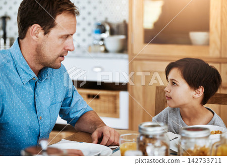 Talking, boy and dad with breakfast in kitchen for communication, nutrition and development. Hungry, man and kid chat in home with drink for wellness, love and health food or conversation and bonding 142733711