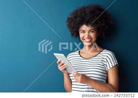 African woman, tablet and smile in studio portrait with space for mock up with study on app by blue background. Person, girl and click on digital touchscreen, online course or elearning for education African woman, tablet and smile in studio portrait with space for mock up with study on app by blue background. Person, girl and click on digital touchscreen, online course or elearning for education 142733712