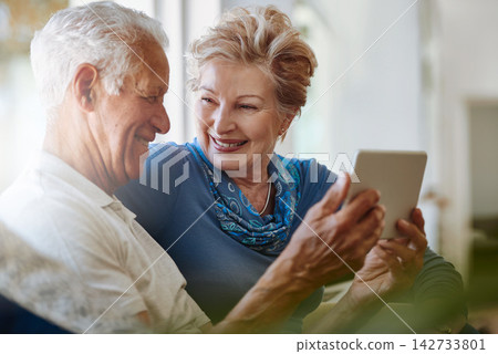 Senior couple, online and tablet for streaming, digital and download for movie, watch show and app in house. Conversation, man and woman with media news to relax in home, smile and love in retirement Senior couple, online and tablet for streaming, digital and download for movie, watch show and app in house. Conversation, man and woman with media news to relax in home, smile and love in retirement 142733801