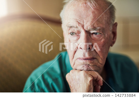Elderly, man and sad with thinking of memory in retirement home with remember, nostalgia or reflection on sofa. Senior, person and lonely with alzheimers, depression and thoughtful on couch in lounge 142733884