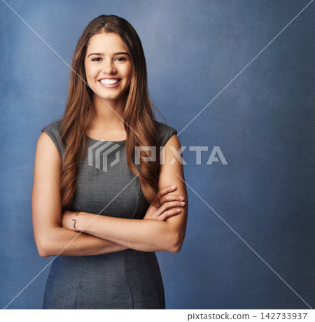 Reporter, portrait and studio for arms crossed, proud or confidence for goals. Creative writer, news editor or happy businesswoman for content creation, publishing or press startup on blue background Reporter, portrait and studio for arms crossed, proud or confidence for goals. Creative writer, news editor or happy businesswoman for content creation, publishing or press startup on blue background 142733937