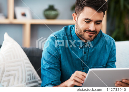 Businessman, tablet and happy working from home for remote job, internet search or social media. Male person, smile and confident on sofa with technology for graphic design or online communication Businessman, tablet and happy working from home for remote job, internet search or social media. Male person, smile and confident on sofa with technology for graphic design or online communication 142733940