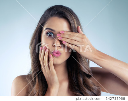 Beauty, manicure and wow with portrait of woman in studio on blue background for aesthetic wellness. Cosmetics, funny face and makeup with happy model at salon for nail polish treatment or surprise Beauty, manicure and wow with portrait of woman in studio on blue background for aesthetic wellness. Cosmetics, funny face and makeup with happy model at salon for nail polish treatment or surprise 142733966