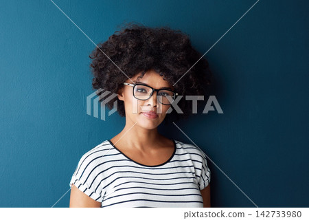 Black woman, portrait and serious with glasses for optometry or vision and on blue studio background. Girl, spectacle and confident for wellness, eye care and healthcare with beauty or mockup space Black woman, portrait and serious with glasses for optometry or vision and on blue studio background. Girl, spectacle and confident for wellness, eye care and healthcare with beauty or mockup space 142733980