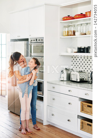 Woman, happy and kid with hug in family home for love, connection and bonding together in morning. Kitchen, embrace and mother with daughter in house for affection, care and support on weekend Woman, happy and kid with hug in family home for love, connection and bonding together in morning. Kitchen, embrace and mother with daughter in house for affection, care and support on weekend 142734055