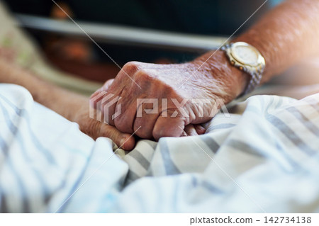 Senior person, holding hands and visit with hospital, closeup and elderly care or love together. Elderly people, couple and relationship with medical checkup, help and empathy for surgery recovery Senior person, holding hands and visit with hospital, closeup and elderly care or love together. Elderly people, couple and relationship with medical checkup, help and empathy for surgery recovery 142734138