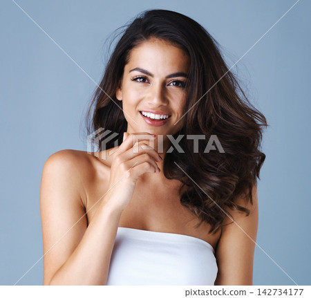 Portrait, hair care and beauty of happy woman with glow, health or thinking of skincare isolated on blue studio background. Face, hairstyle or model in makeup cosmetics at hairdresser salon for shine Portrait, hair care and beauty of happy woman with glow, health or thinking of skincare isolated on blue studio background. Face, hairstyle or model in makeup cosmetics at hairdresser salon for shine 142734177
