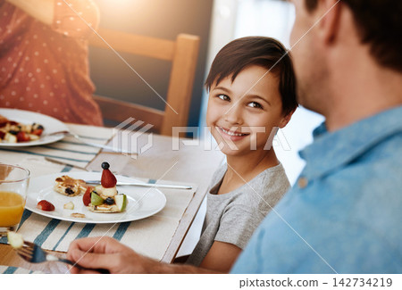 Happy, boy and dad together with breakfast on table for eating, nutrition and sharing with love. Hungry, man and kid in home excited for meal, diet and wellness on social morning with healthy food Happy, boy and dad together with breakfast on table for eating, nutrition and sharing with love. Hungry, man and kid in home excited for meal, diet and wellness on social morning with healthy food 142734219