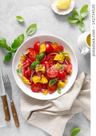 Salad with fresh sweet corn, cherry tomatoes, basil and olive oil Salad with fresh sweet corn, cherry tomatoes, basil and olive oil 142734520
