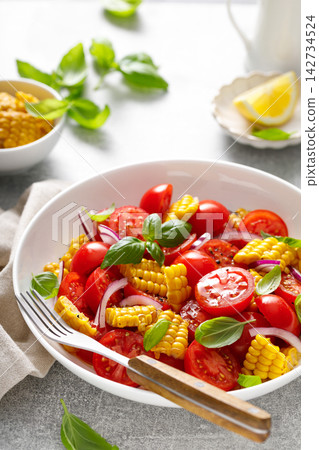 Salad with fresh sweet corn, cherry tomatoes, basil and olive oil Salad with fresh sweet corn, cherry tomatoes, basil and olive oil 142734524