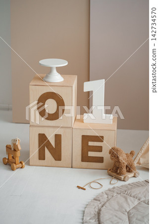 Minimalist 1st birthday studio setup with ONE wooden blocks and white cake stand Minimalist 1st birthday studio setup with ONE wooden blocks and white cake stand 142734570