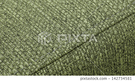 Textured green textile background with diagonal stitching Textured green textile background with diagonal stitching 142734581