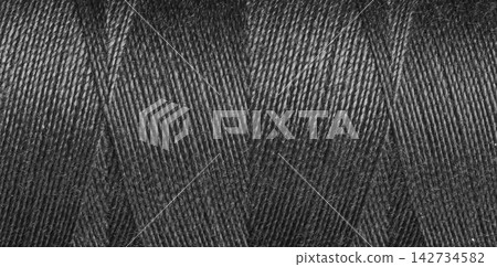 Close-up texture of Black sewing threads on a spool Close-up texture of Black sewing threads on a spool 142734582
