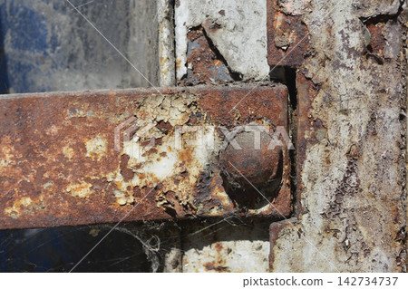 Rusty metal hinge with flaking paint and corrosion Rusty metal hinge with flaking paint and corrosion 142734737