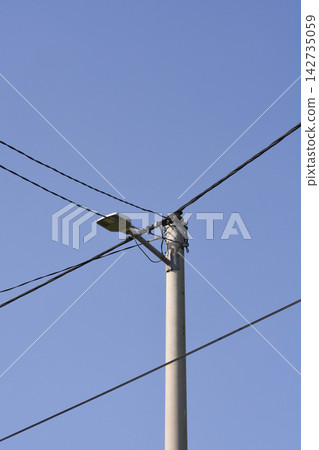 Concrete Utility Pole with Street Lamp and Wires Concrete Utility Pole with Street Lamp and Wires 142735059