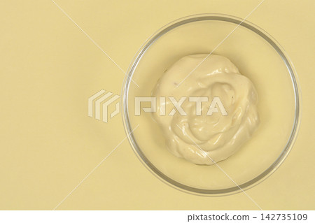 Homemade creamy mayonnaise in a glass bowl 142735109