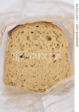 Slice of multi seed bread in plastic bag 142735249