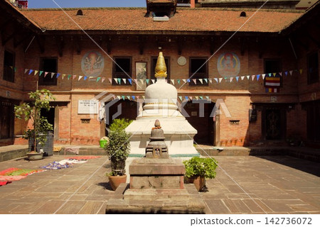 Stupas and prayer flags in a Buddhist monastery in Nepal 142736072