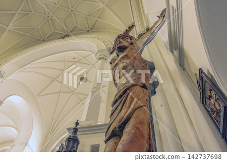 Nitra, Slovakia - May 23, 2024: Wooden Figure of Jesus Christ Seen from Below Inside a Catholic Church Nitra, Slovakia - May 23, 2024: Wooden Figure of Jesus Christ Seen from Below Inside a Catholic Church 142737698