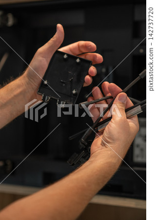 Hands holding coffee machine components for cleaning and maintenance in a kitchen setting Hands holding coffee machine components for cleaning and maintenance in a kitchen setting 142737720