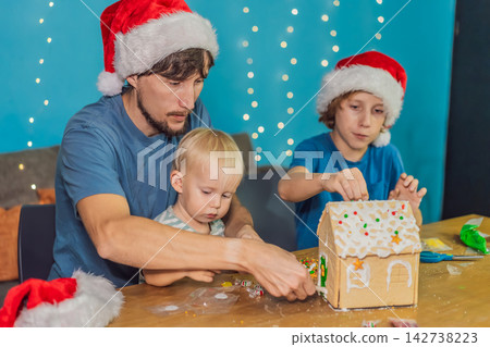 Dad helps kids make a festive gingerbread house, capturing Christmas holiday, family bonding, creativity and home celebration concept Dad helps kids make a festive gingerbread house, capturing Christmas holiday, family bonding, creativity and home celebration concept 142738223