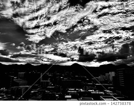 The cityscape of Sapporo, the mountain range centered around Mount Sankaku, and the vast sky. The cityscape of Sapporo, the mountain range centered around Mount Sankaku, and the vast sky. 142738378