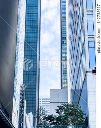 A cityscape of a business district with a cluster of modern skyscrapers. A cityscape of a business district with a cluster of modern skyscrapers. 142738627