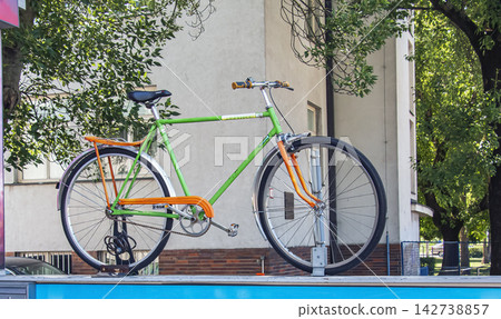 Nitra, Slovakia - May 27, 2024: Colorful Bicycle Displayed Above a Cycling Store Nitra, Slovakia - May 27, 2024: Colorful Bicycle Displayed Above a Cycling Store 142738857