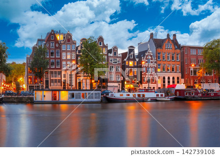 Amsterdam Canal Houses and Houseboats at Twilight with Reflections Amsterdam Canal Houses and Houseboats at Twilight with Reflections 142739108