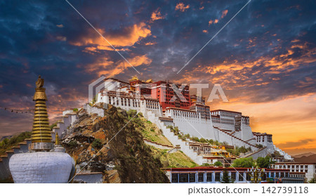 Potala Palace in Lhasa, Tibet at sunset with dramatic orange and blue sky Potala Palace in Lhasa, Tibet at sunset with dramatic orange and blue sky 142739118