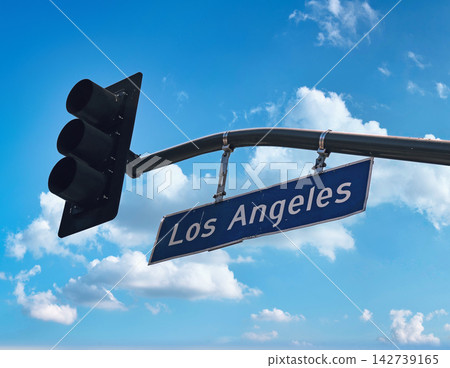 Los Angeles street sign with traffic light against blue sky Los Angeles street sign with traffic light against blue sky 142739165