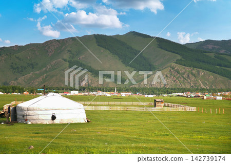 Traditional Mongolian Yurt on Green Grassland with Mountains in Ulaanbaatar Traditional Mongolian Yurt on Green Grassland with Mountains in Ulaanbaatar 142739174
